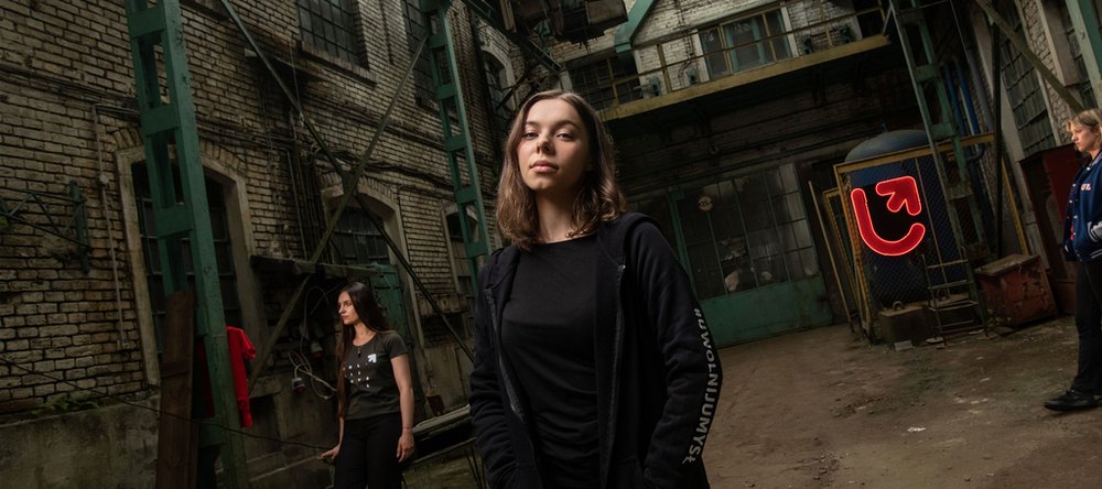 young women standing in a former factory space