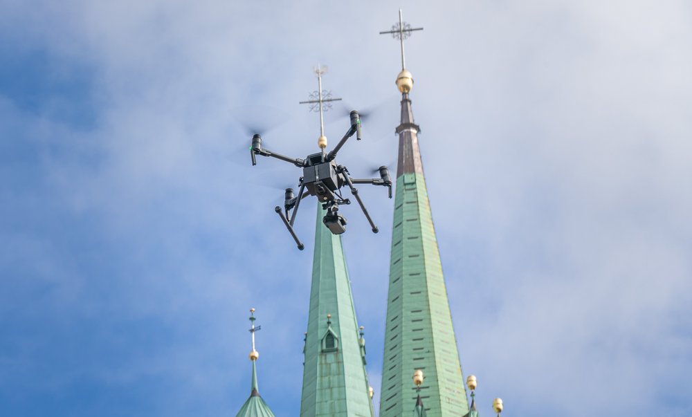 a police drone in flight over a cathedral