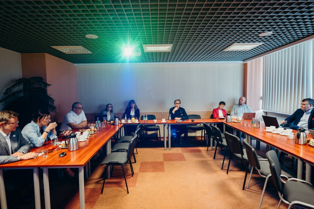 a group of people sitting at tables with refreshments
