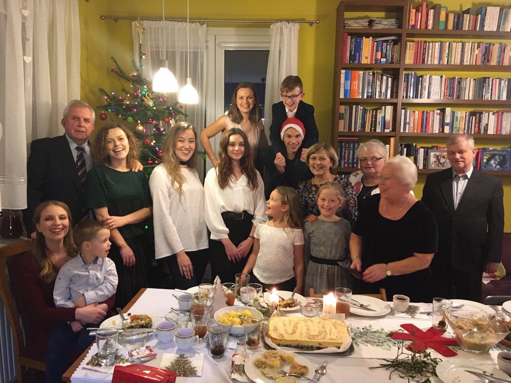 a group photo of a family taking part in the campaign with their international guests
