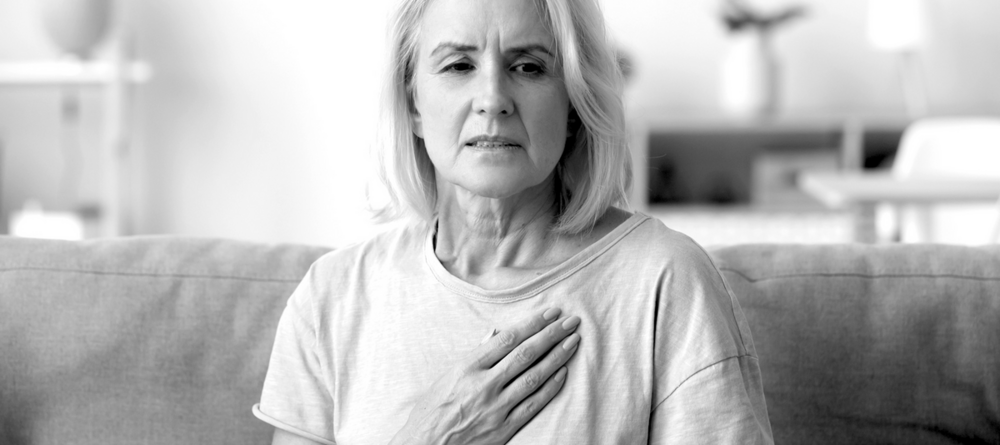 a woman clutchng her chest