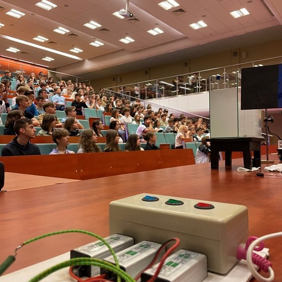 the assembly hall where the meeting participants are present, and there is a device on the lecture counter