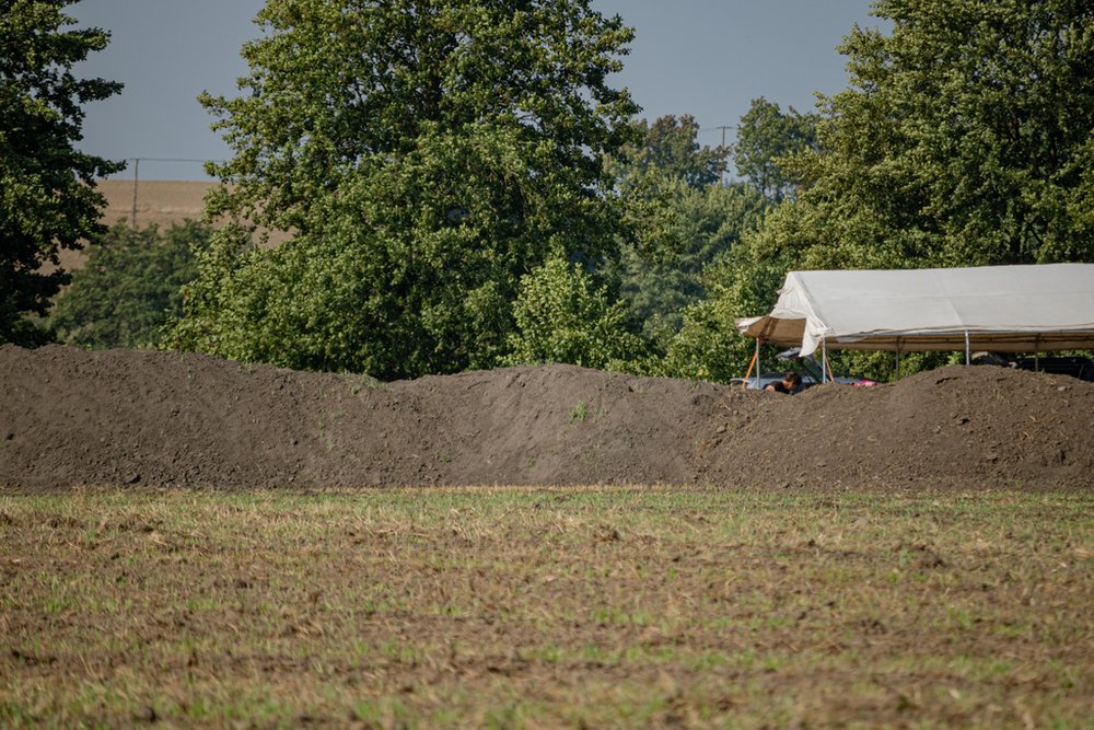 pole z namiotem i kopcem ziemi