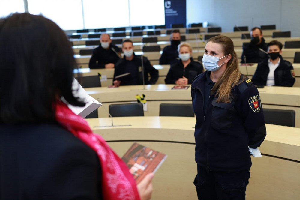 Collecting the diploma by a female city guard officer.