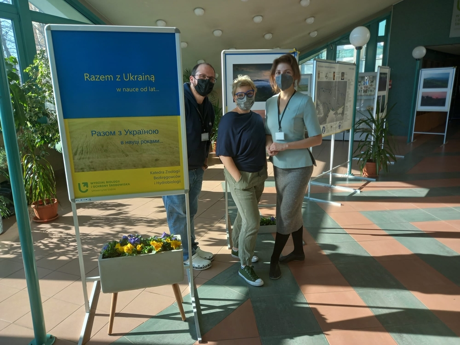two women and a man wearing protective face masks at a photo exhibition two women and a man wearing protective face masks at a photo exhibition