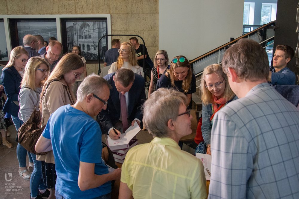 Members of the audience standing in line for autographs