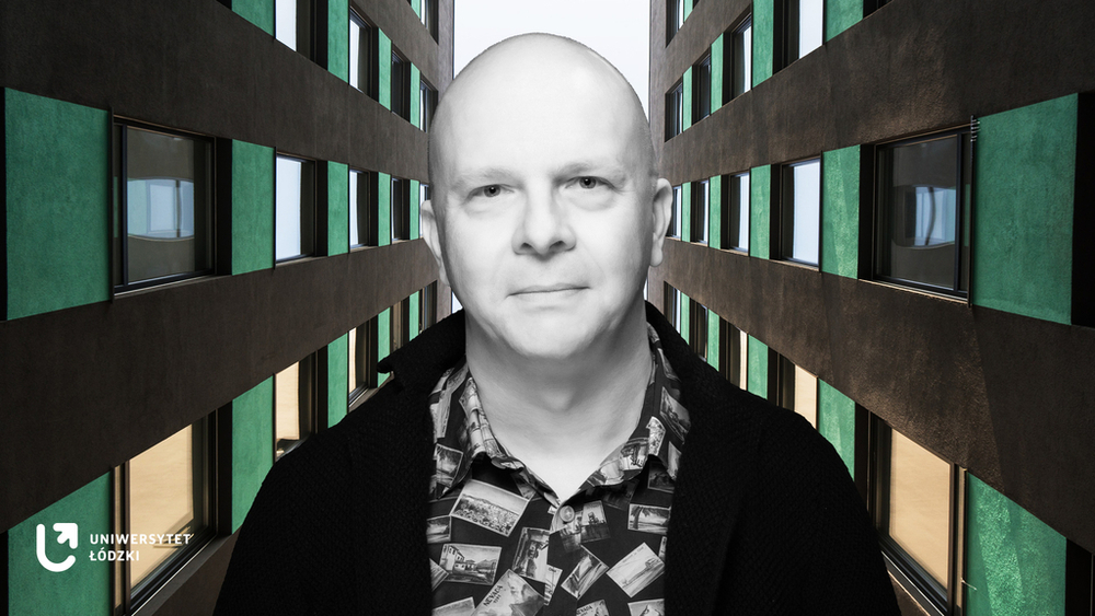 A portrait photo of Dr Tomasz Napierała between two soaring office buildings A portrait photo of Dr Tomasz Napierała between two soaring office buildings