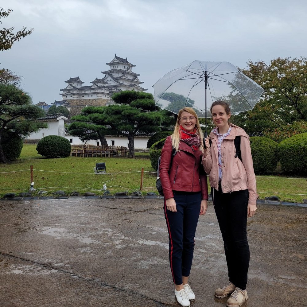Researchers against the background of a Japanese temple