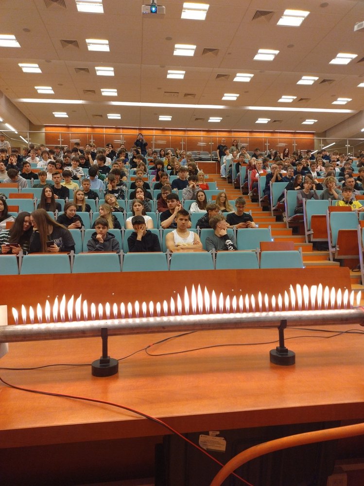 participants of the Science Picnic sitting in the Assembly Hall and watching a physics demonstration