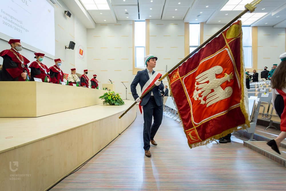 A student with the University's banner