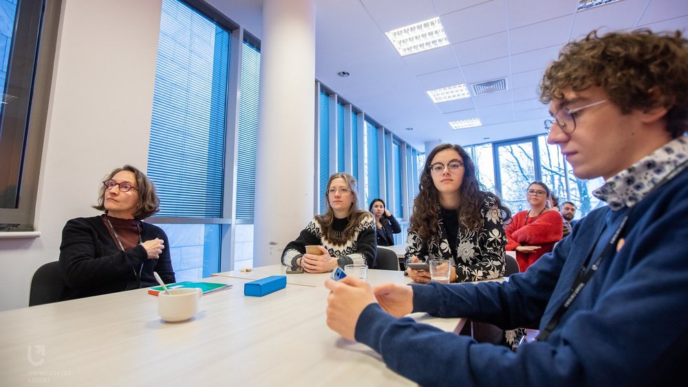 A decoartive element: a group of students working together at a desk