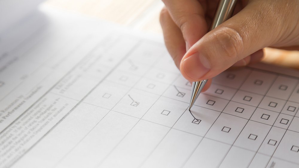 a decorative element: a hand filling in a survey