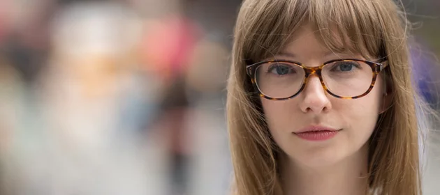 A portrait of a young girl wearing glasses